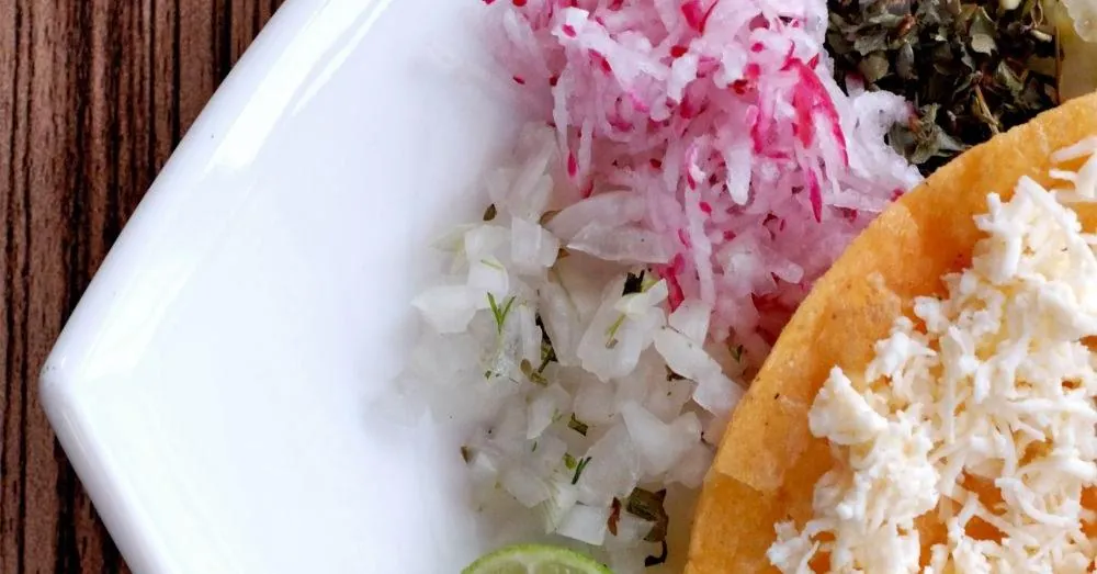 A tostada-style flat tortilla pizza — illustrative photo